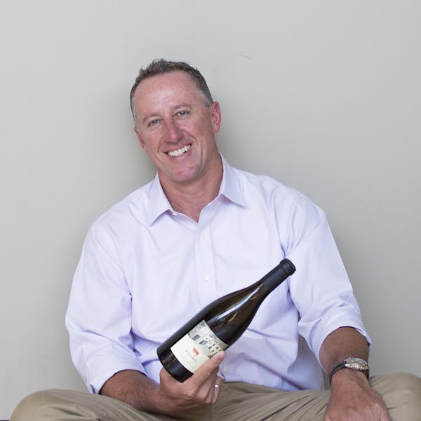 a man sitting in a chair smiling