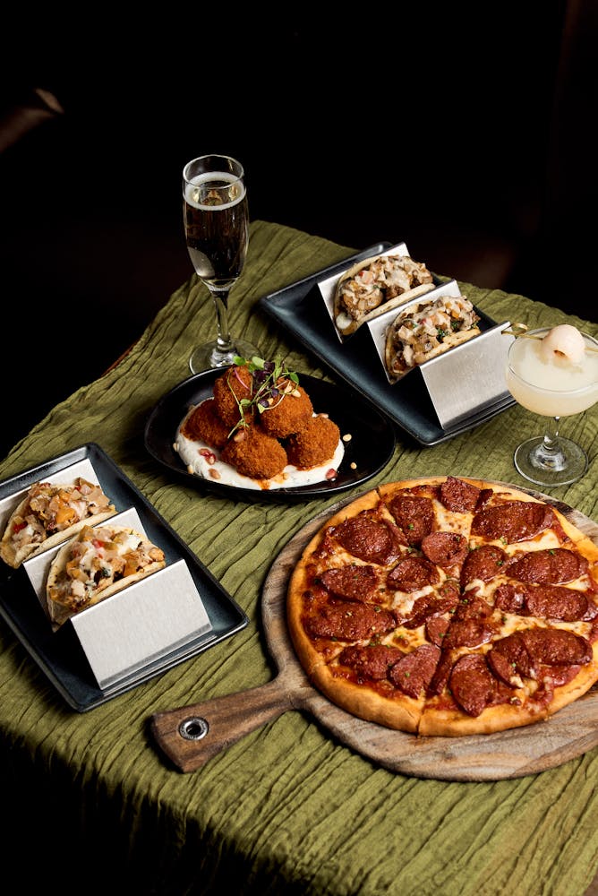 a pizza sitting on top of a wooden table