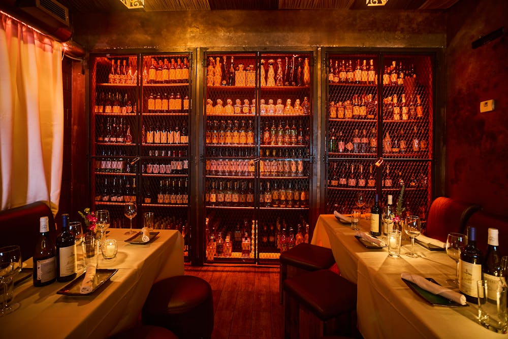 a bunch of vegetables on display lit up at night