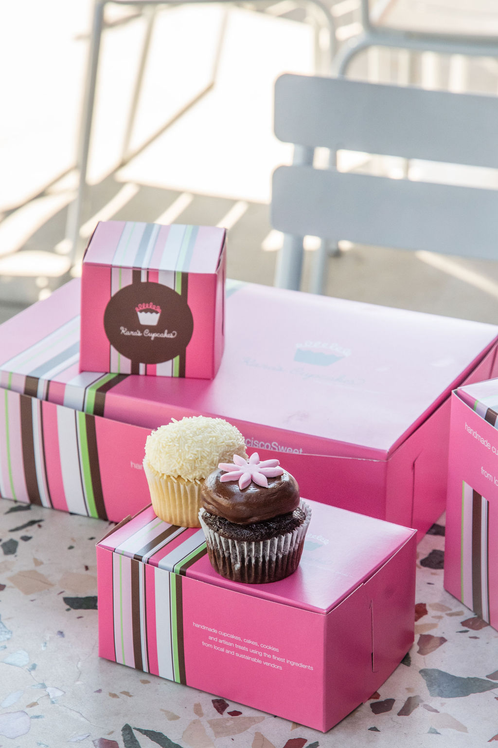 a group of pink boxes with cupcakes