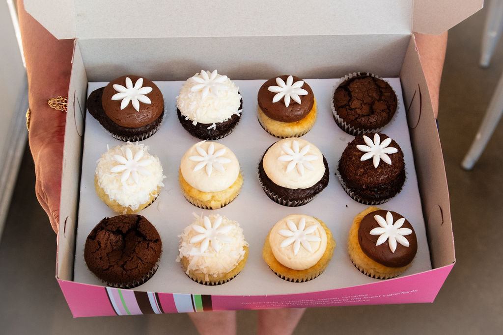 a box filled with different types of cake