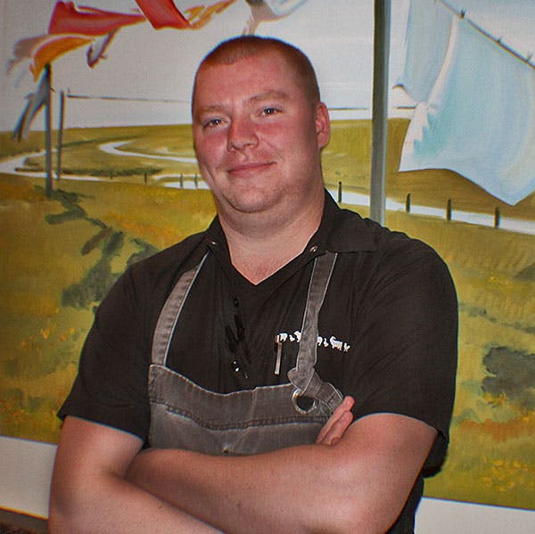 a man sitting in a chair smiling