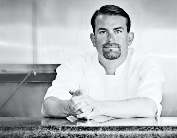 a man sitting on a white surface