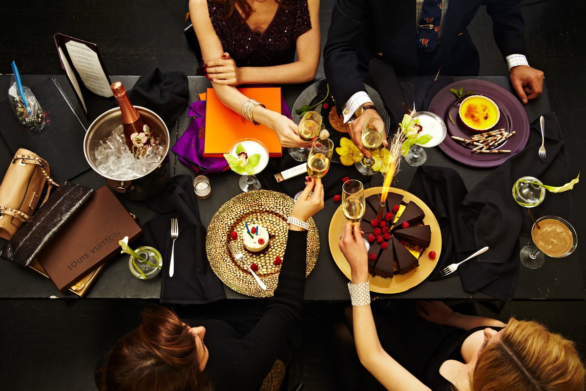 a group of people around a table with plates of food