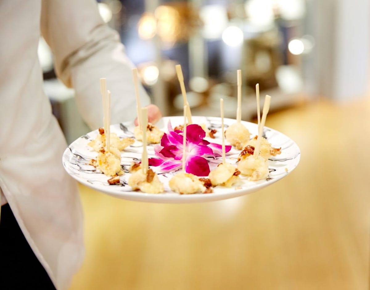 a person sitting at a table with a plate of food