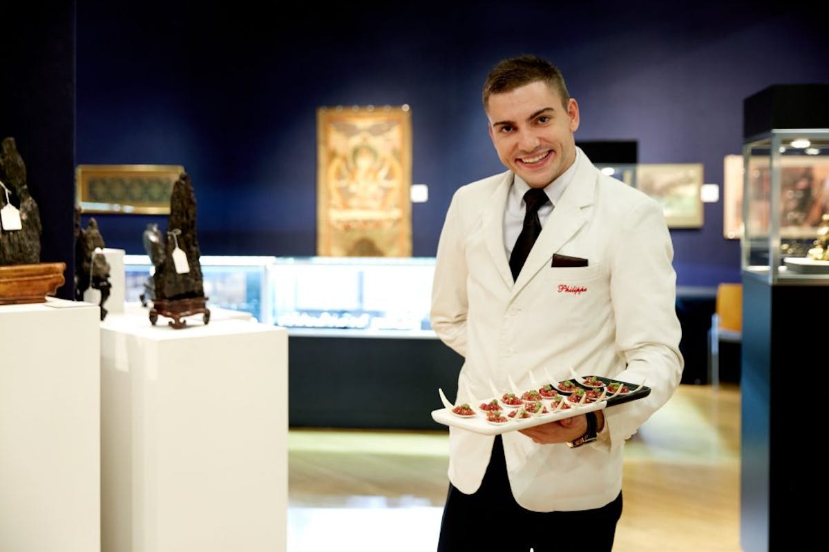 a person standing in front of a cake