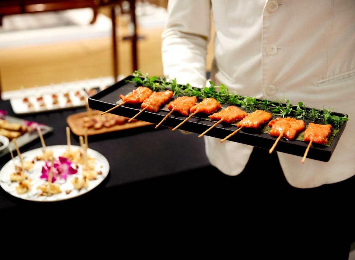 a person sitting at a table with a plate of food