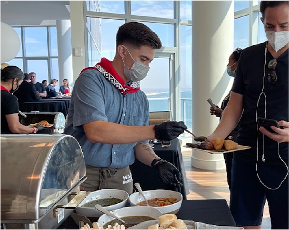 a group of people preparing food on a table