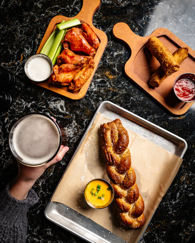 a plate of food and a glass of beer on a table