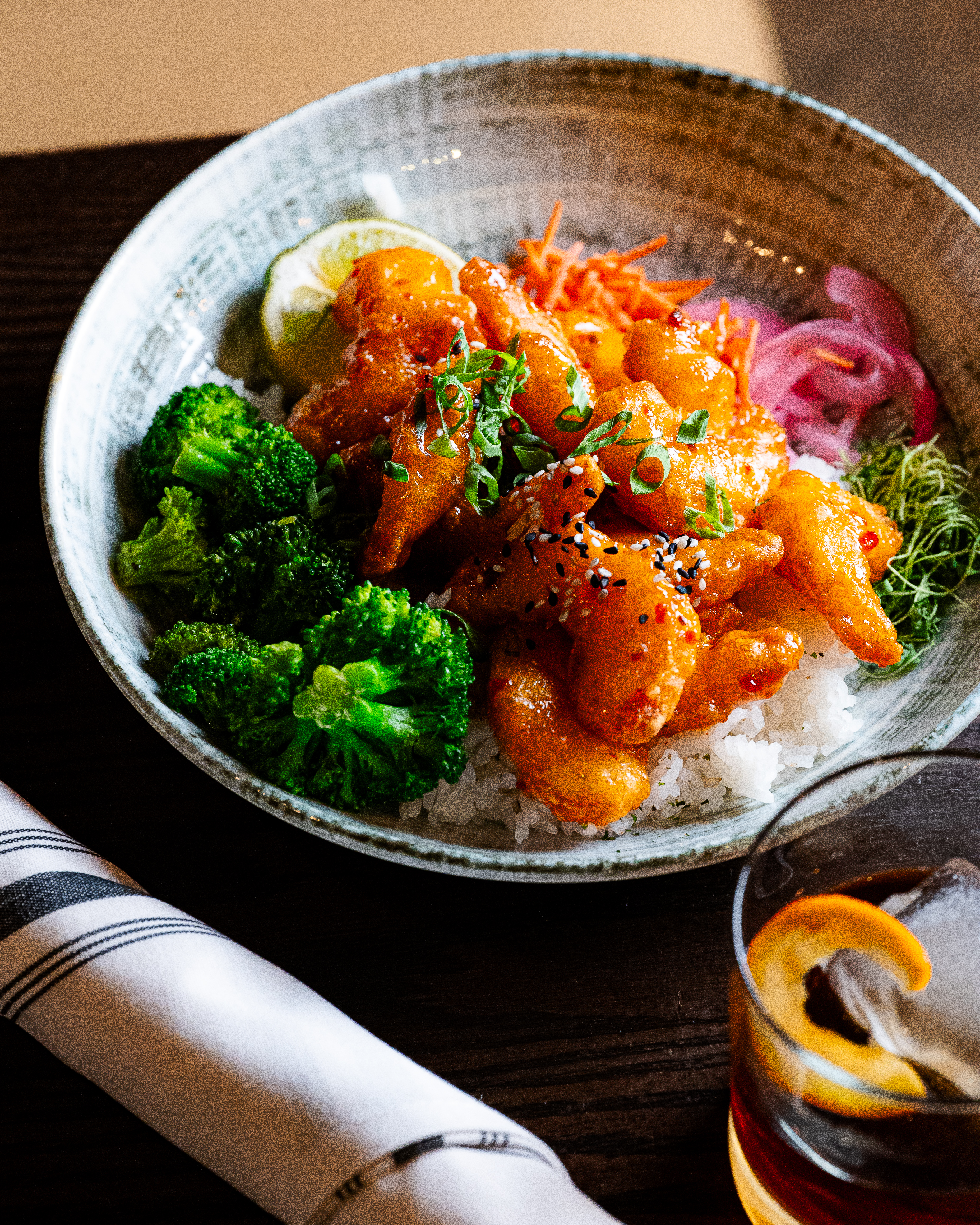 a plate of food and a glass of beer on a table