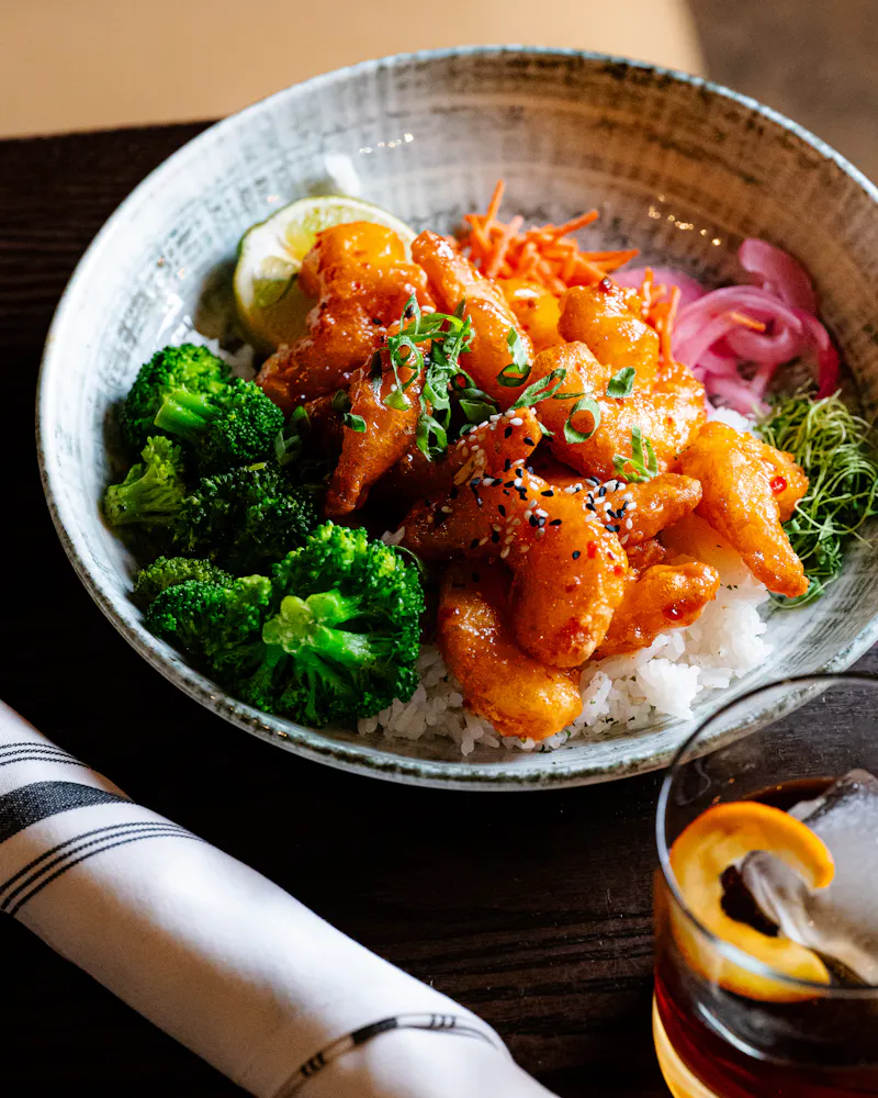 a plate of food and a glass of beer on a table