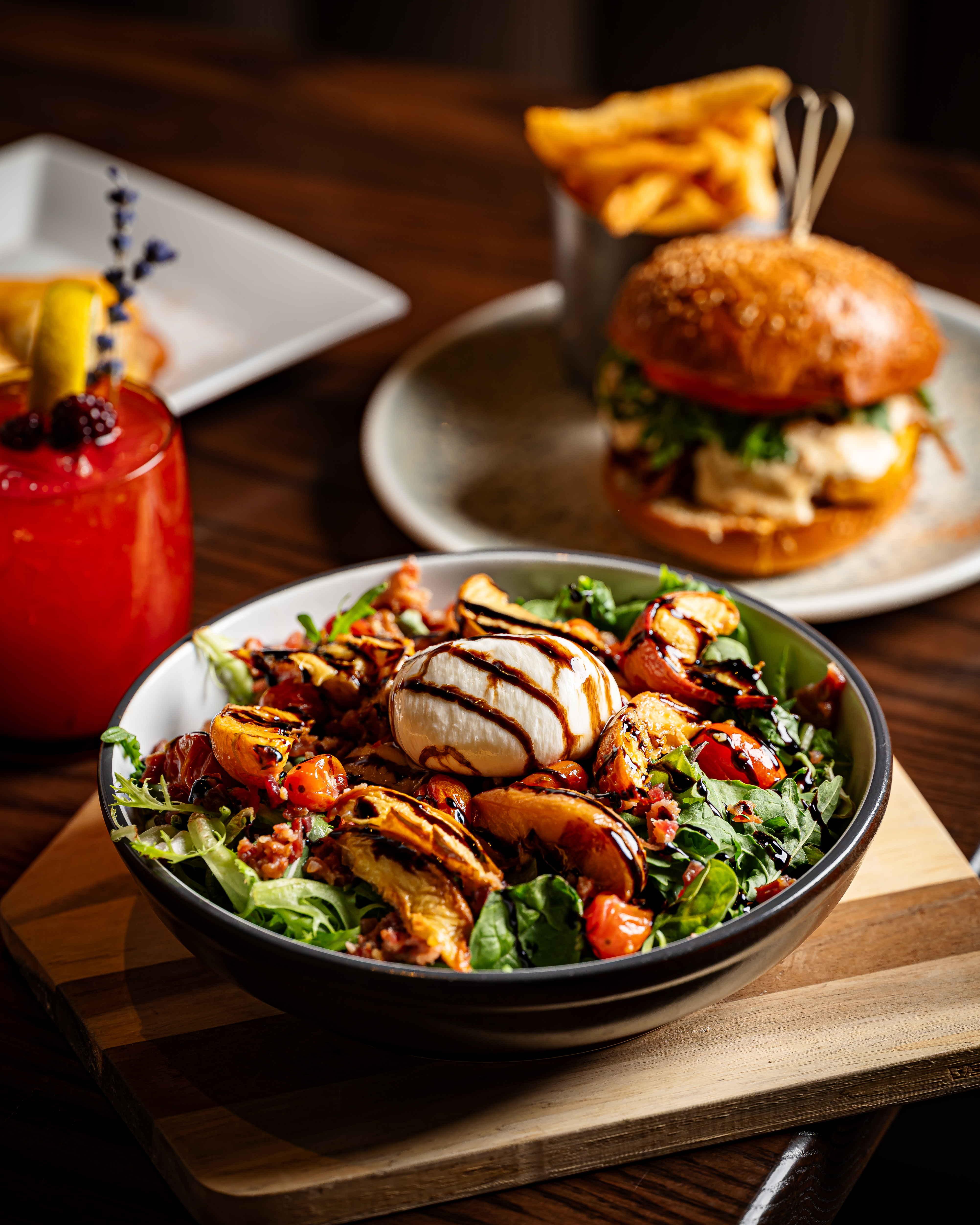 a plate of food and a glass of beer on a table