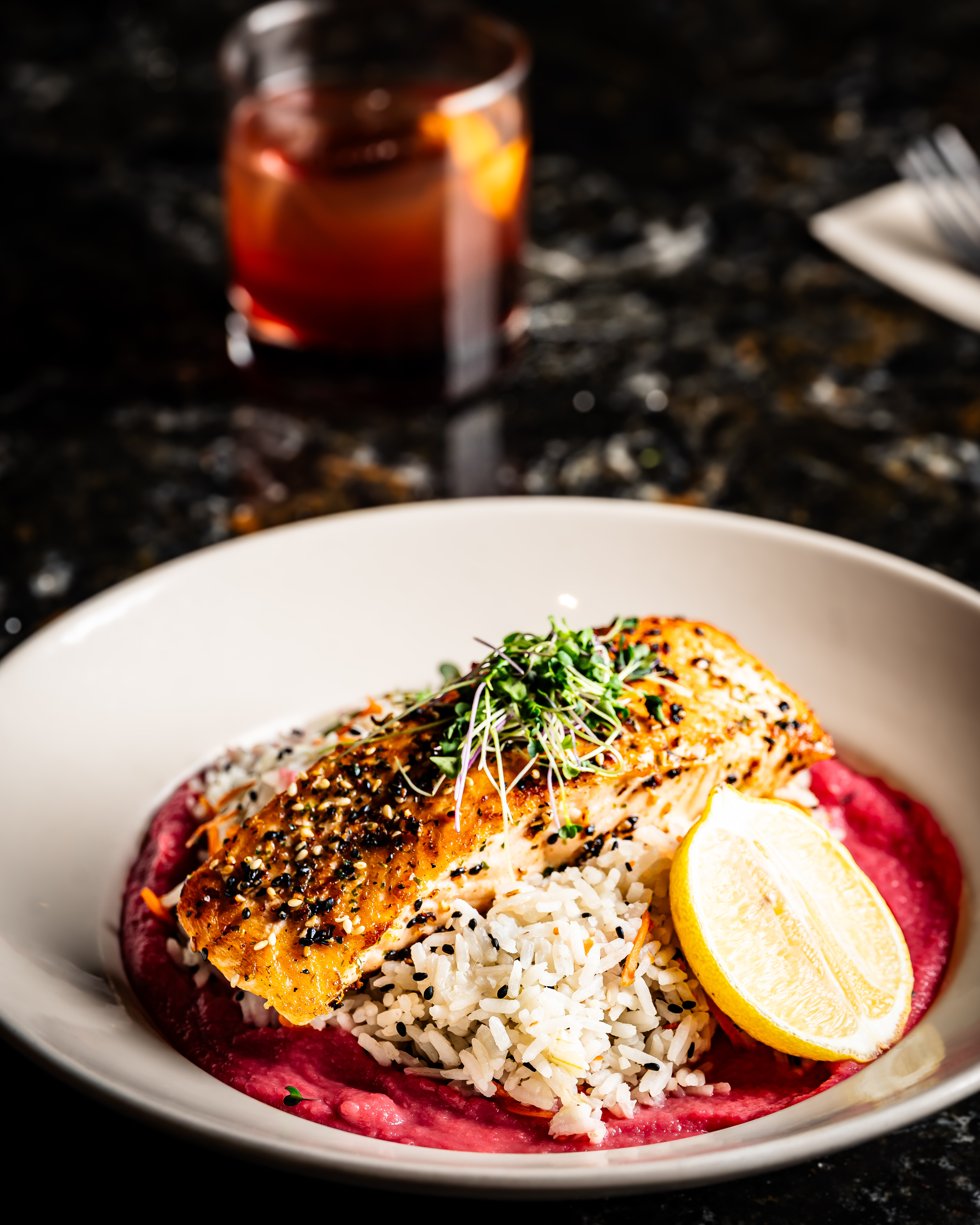 a plate of food and a glass of beer on a table