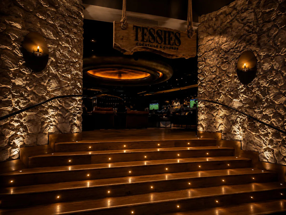 a staircase with lights on the wall
