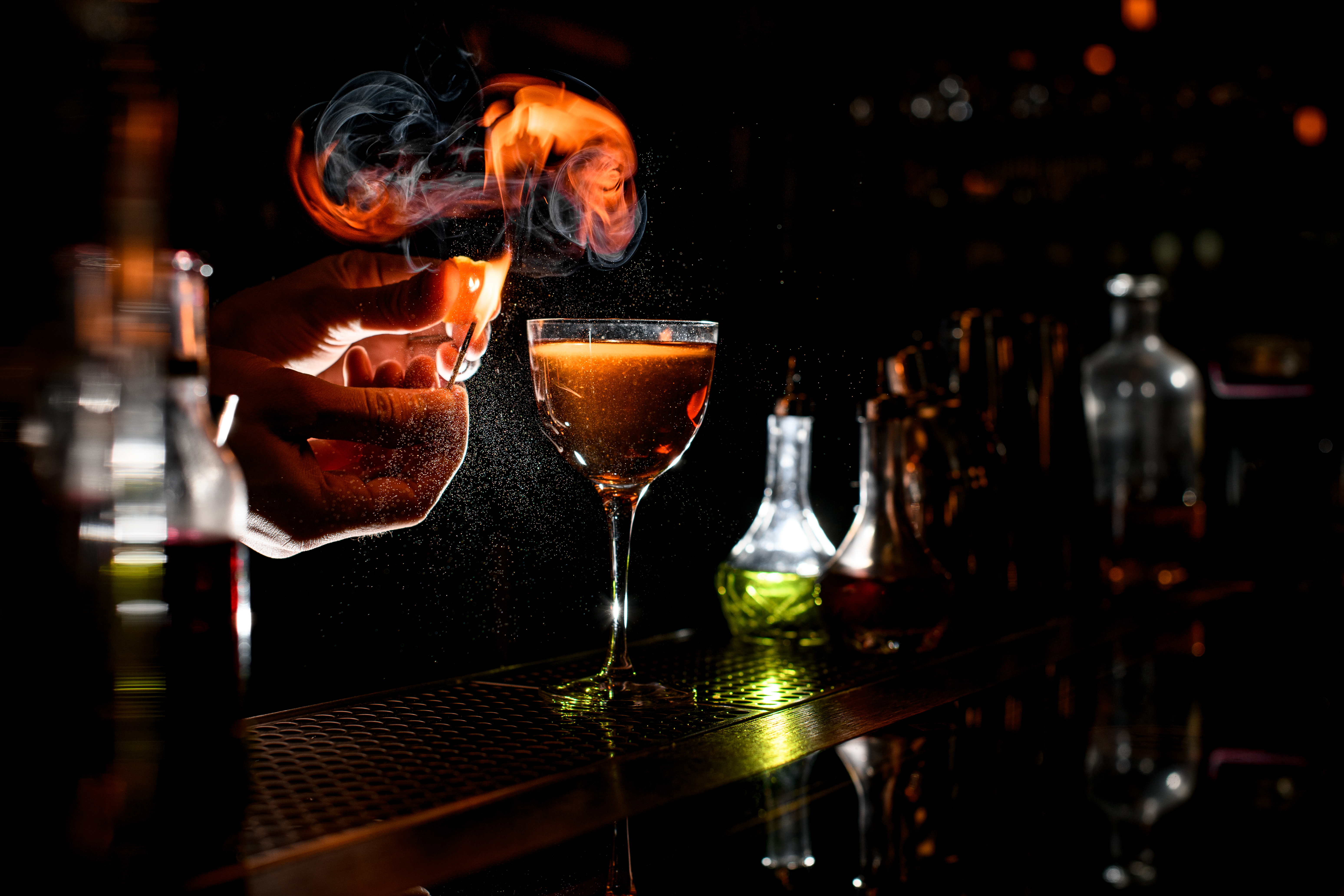 a cocktail sitting on top of a fire at tessie's