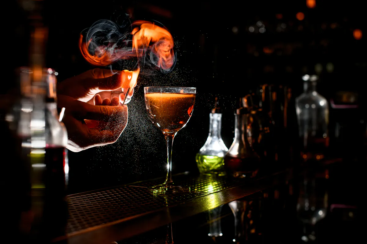 a cocktail sitting on top of a fire at tessie's