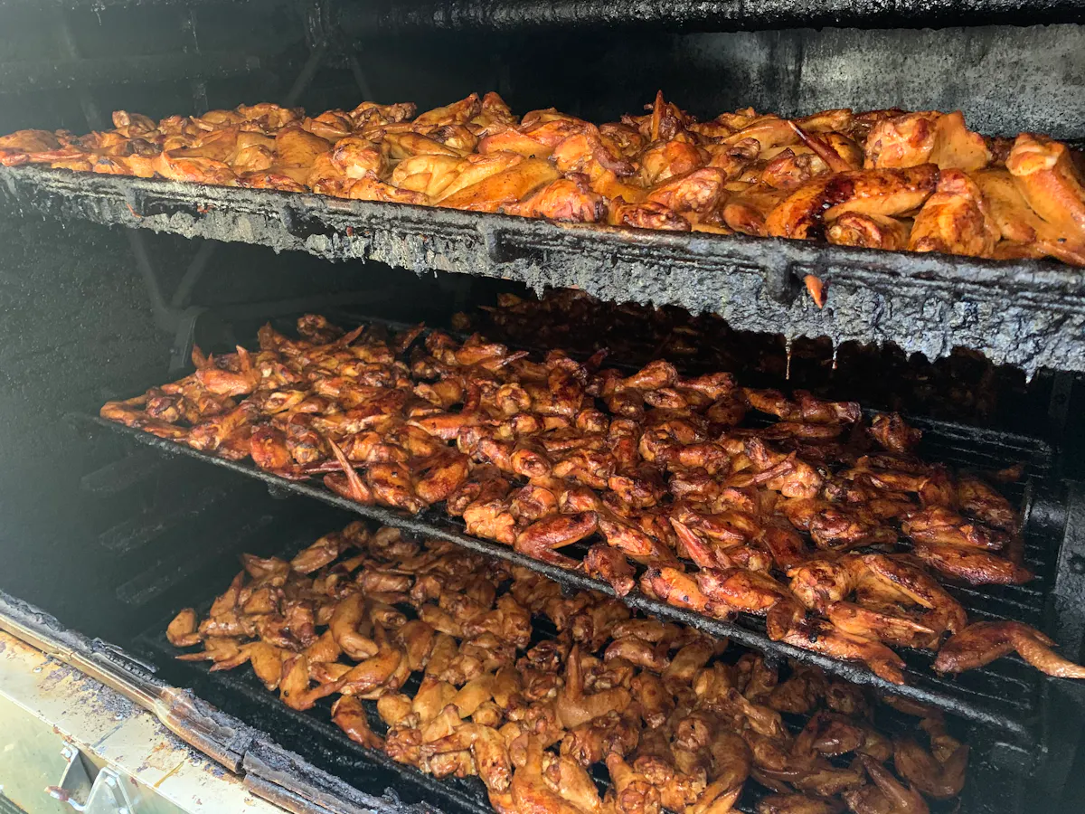 a bunch of hot dogs cooking on a grill