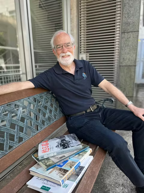 a man sitting in front of a window