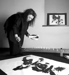 a person sitting at a table with a cake