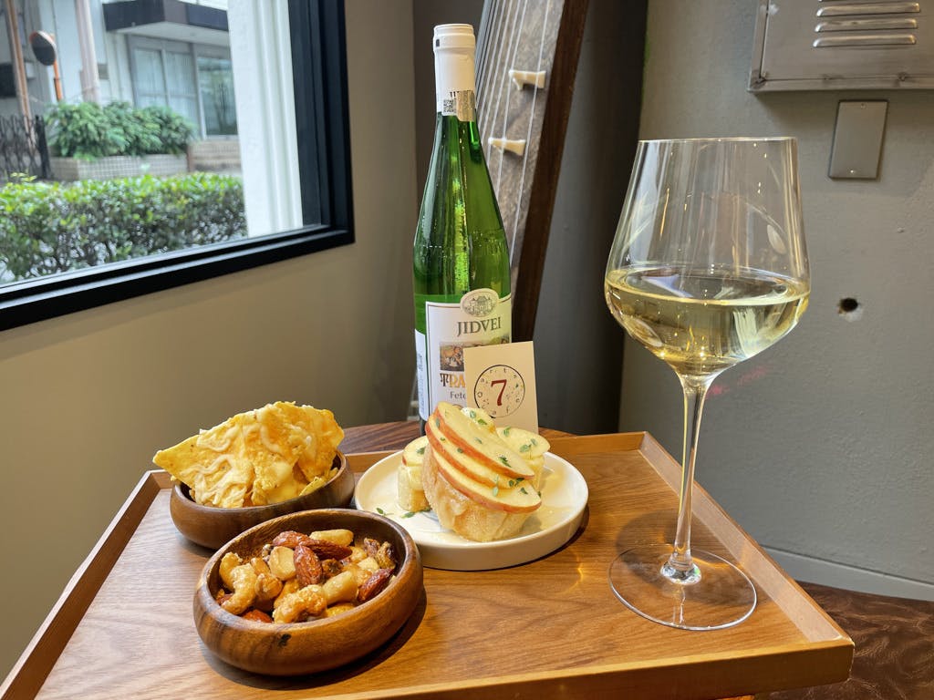 a glass of wine sitting on top of a wooden table