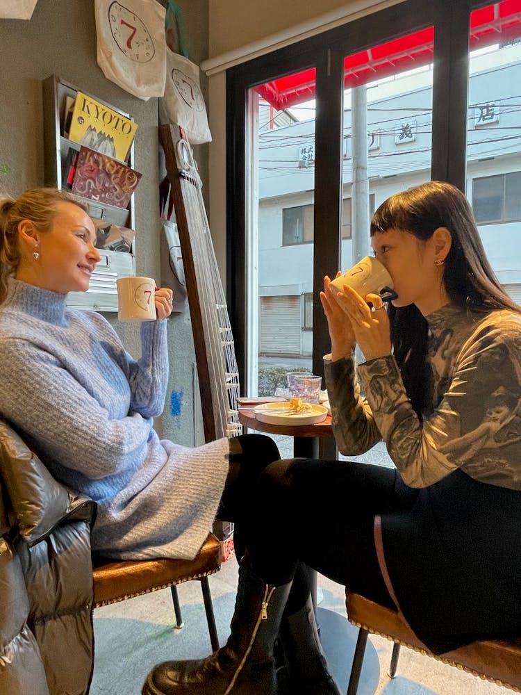 a man and a woman sitting in a chair talking on a cell phone