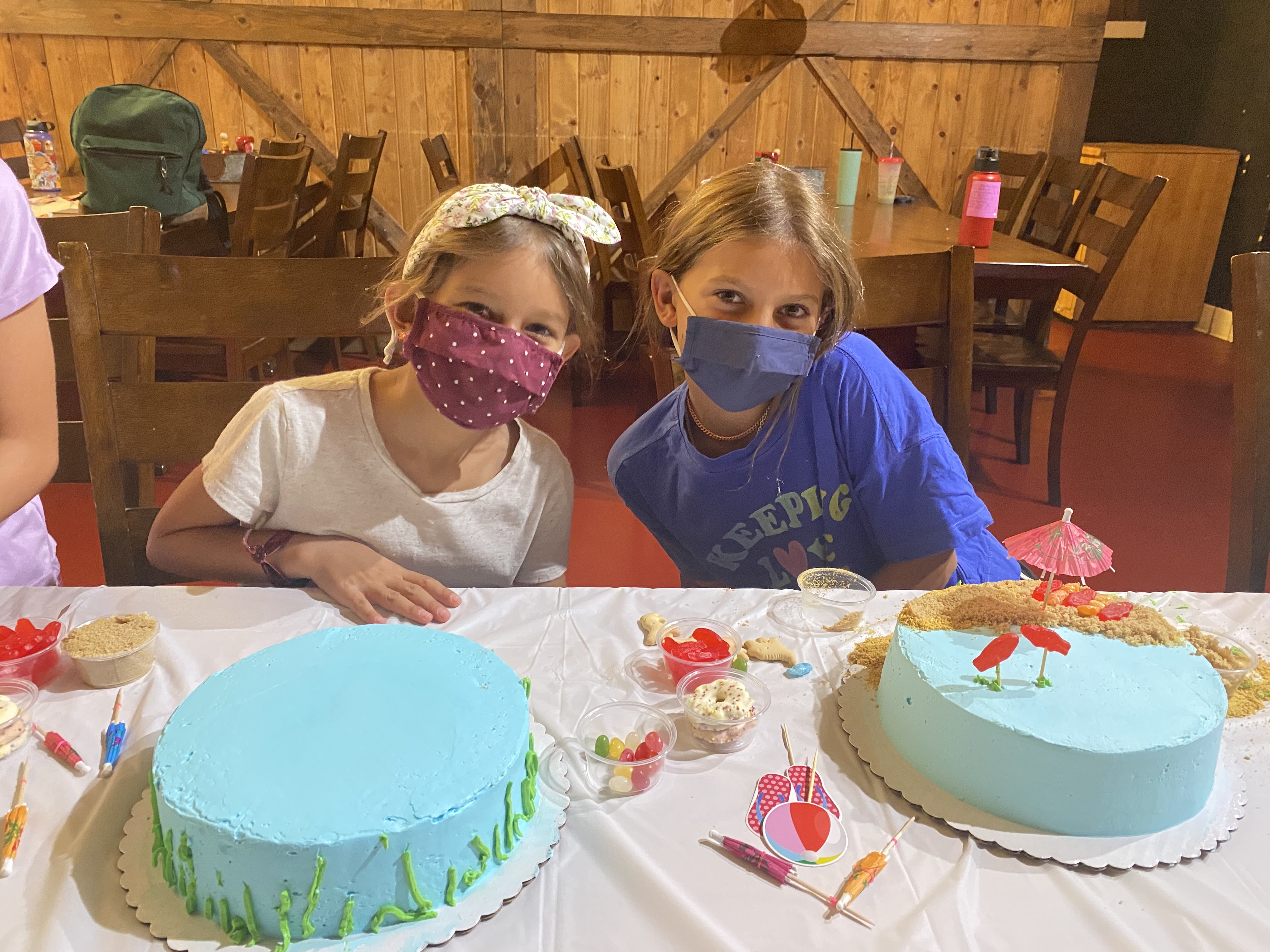 two girls with a blue cake