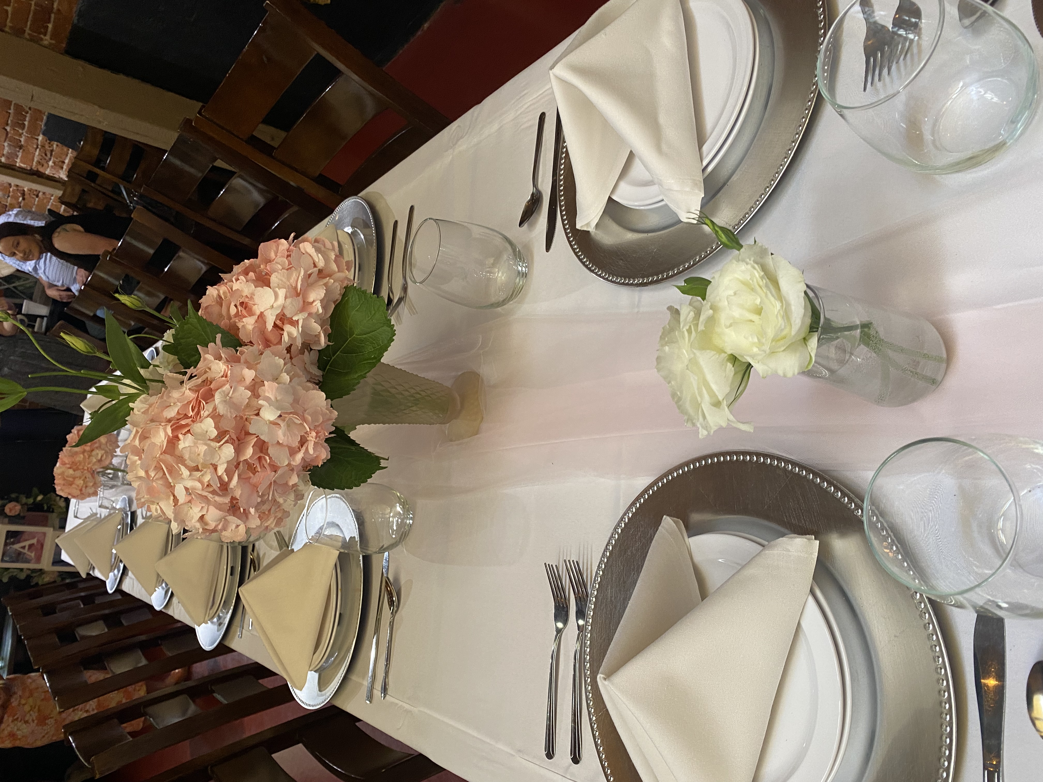 a plate topped with a vase of flowers on a table