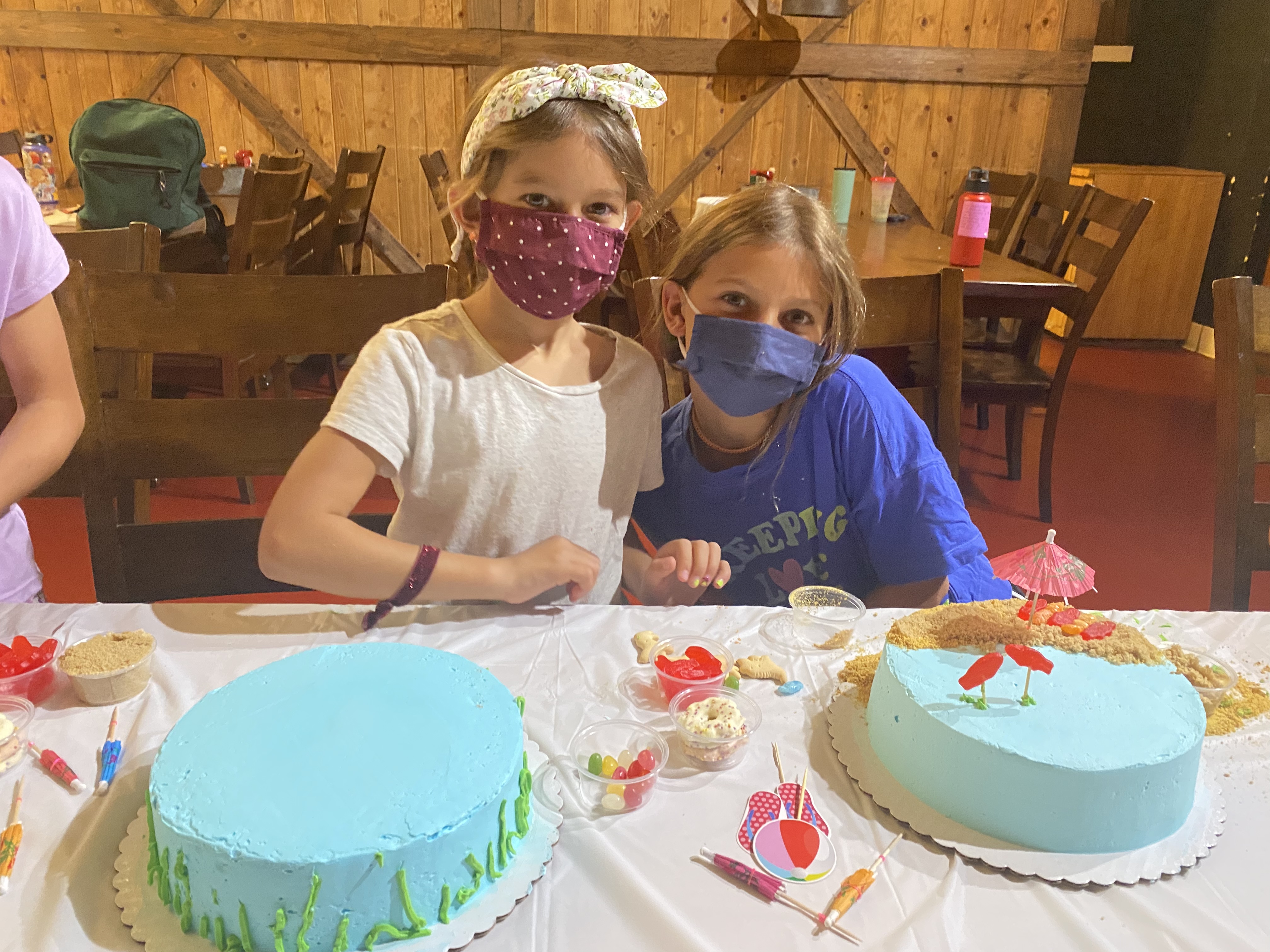a person sitting at a table with a birthday cake