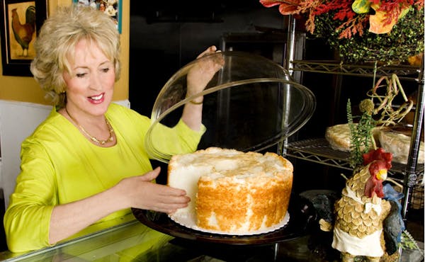 a close up look to a women holding a cake