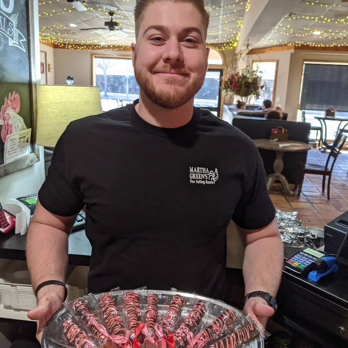 a man standing in front of a table