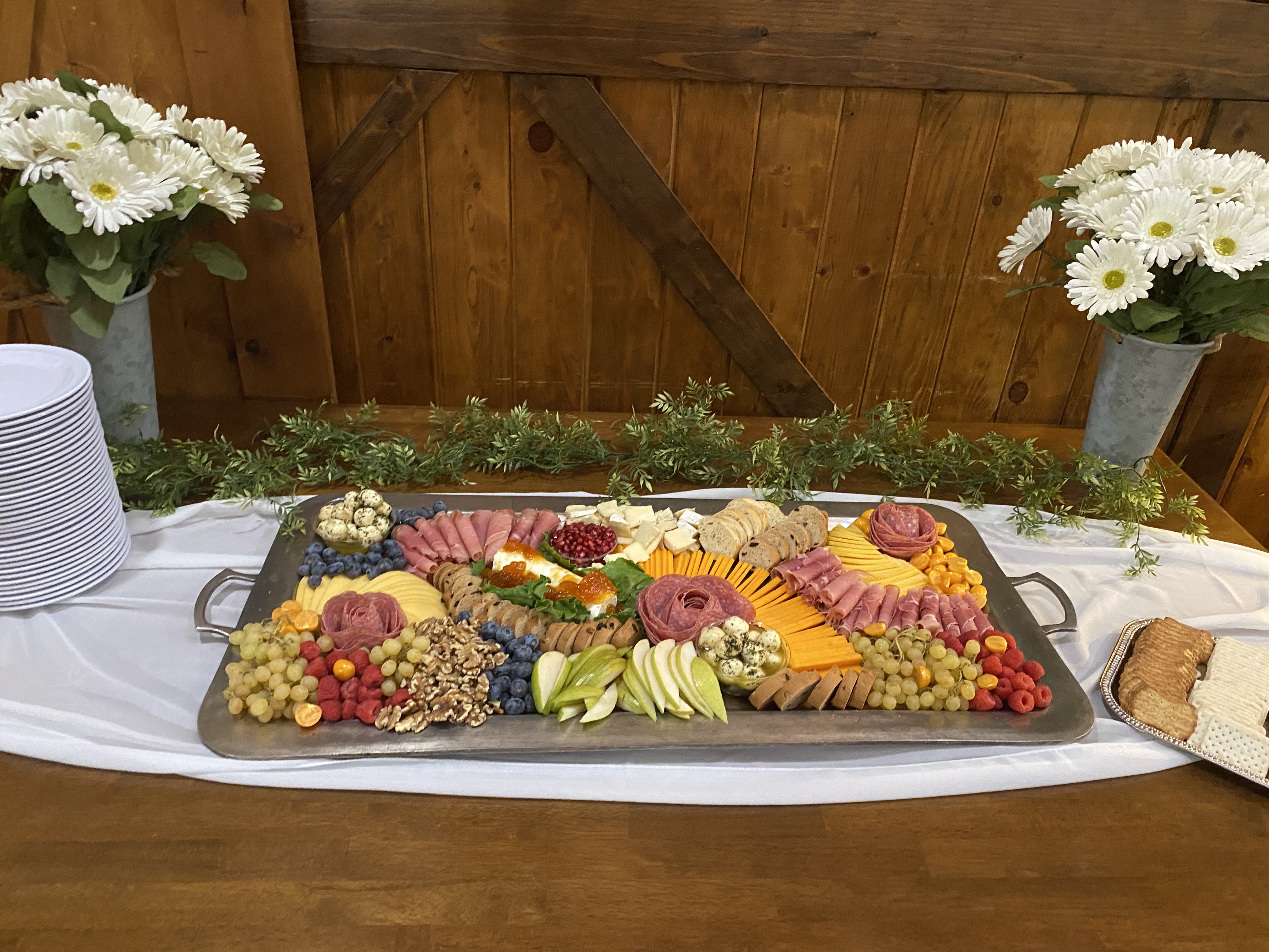 a plate of food and a vase of flowers on a table