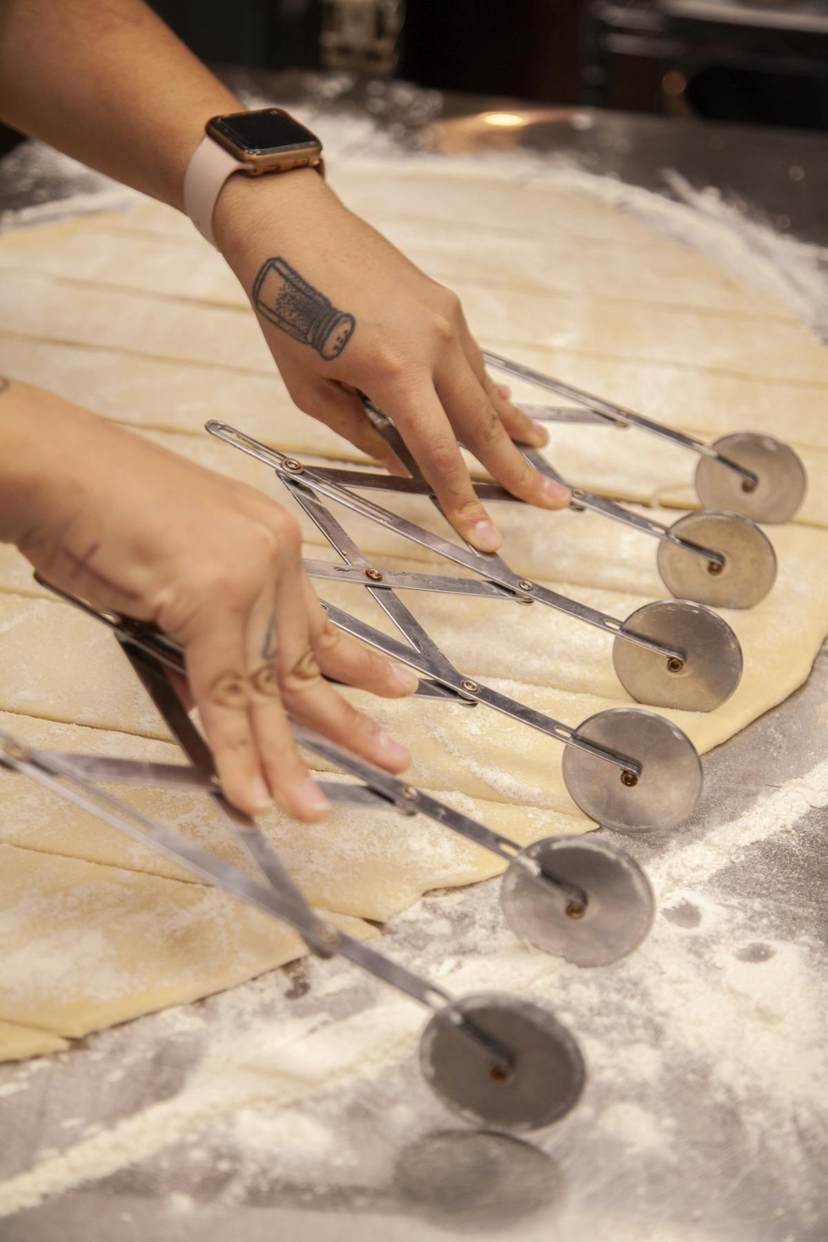 a person cutting a piece of metal pan