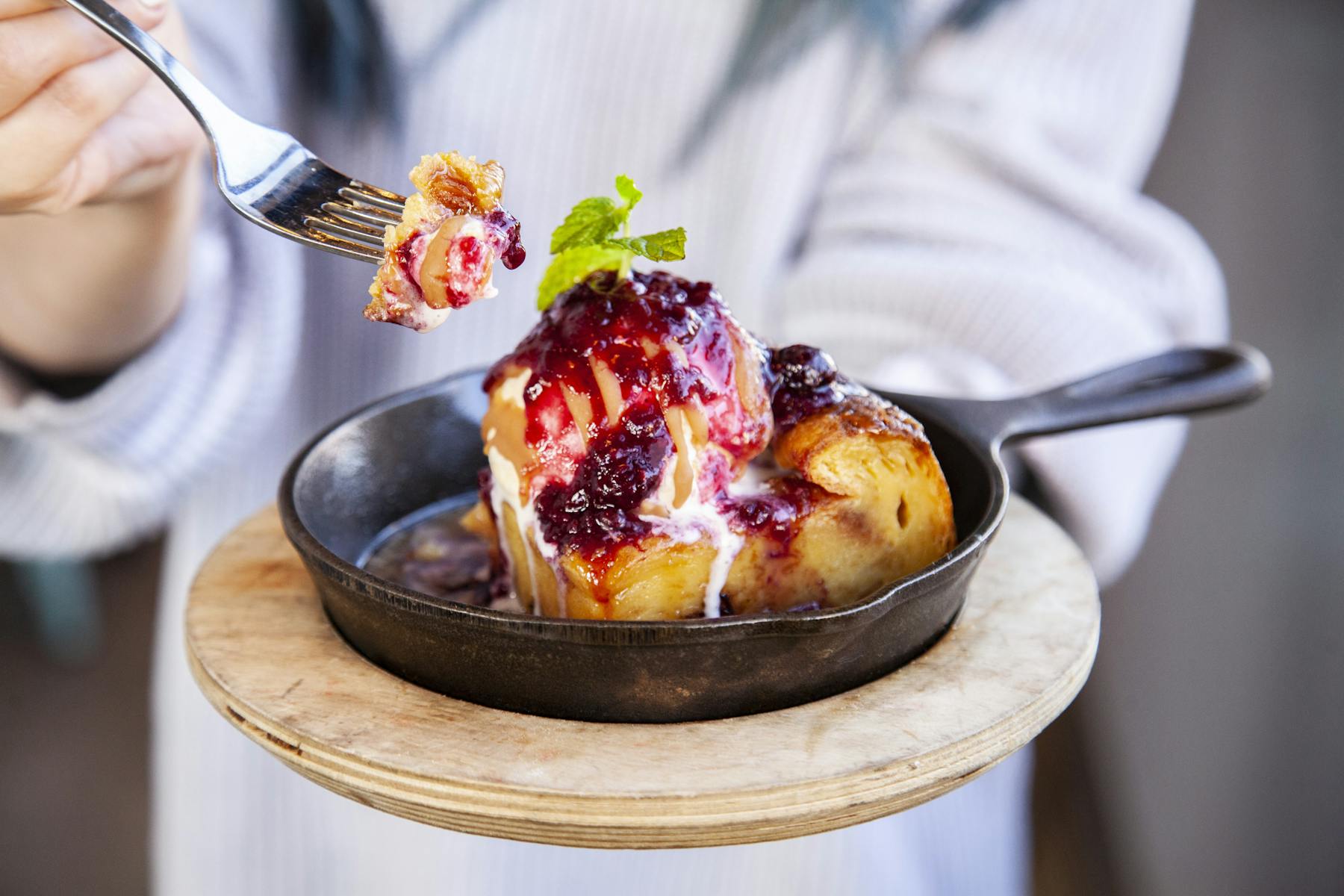 a person holding a bowl of food