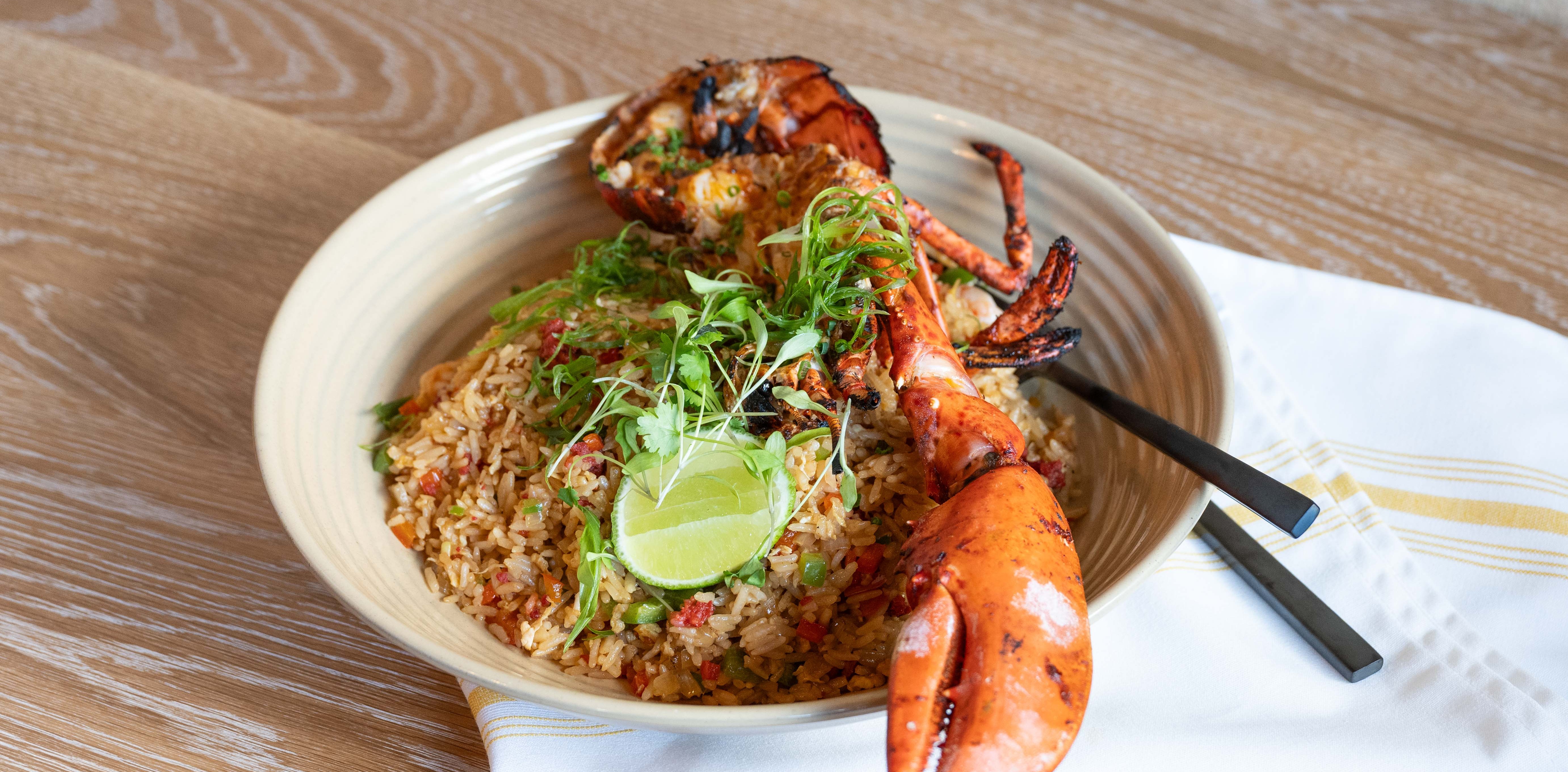 a plate with a lobster and rice