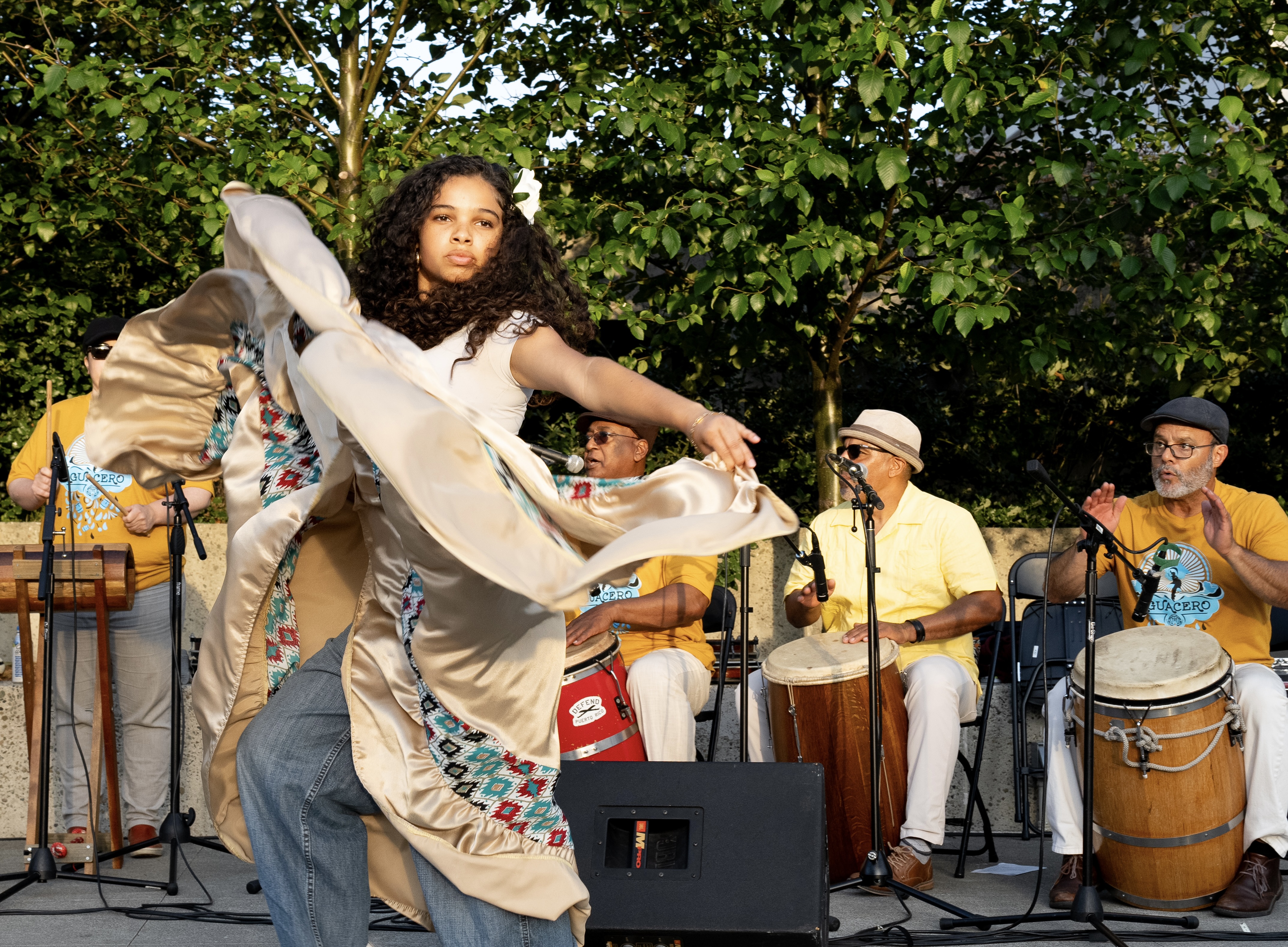 a woman dancing with a group of people playing instruments