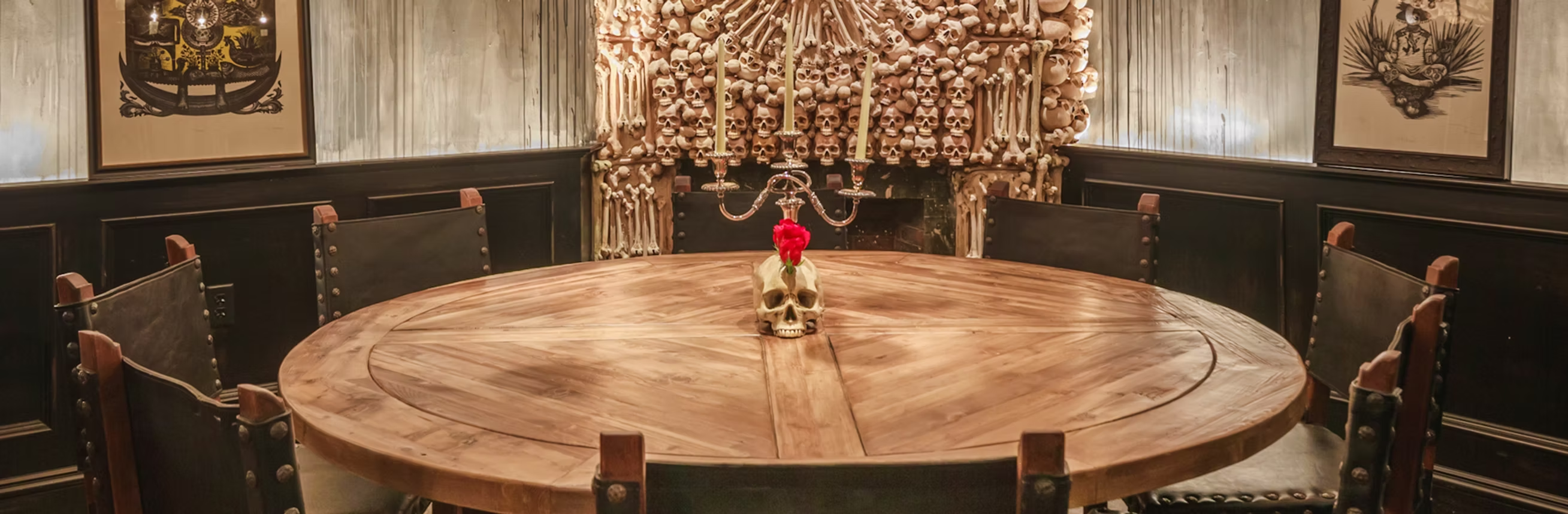 a room filled with furniture and vase of flowers on a wooden table