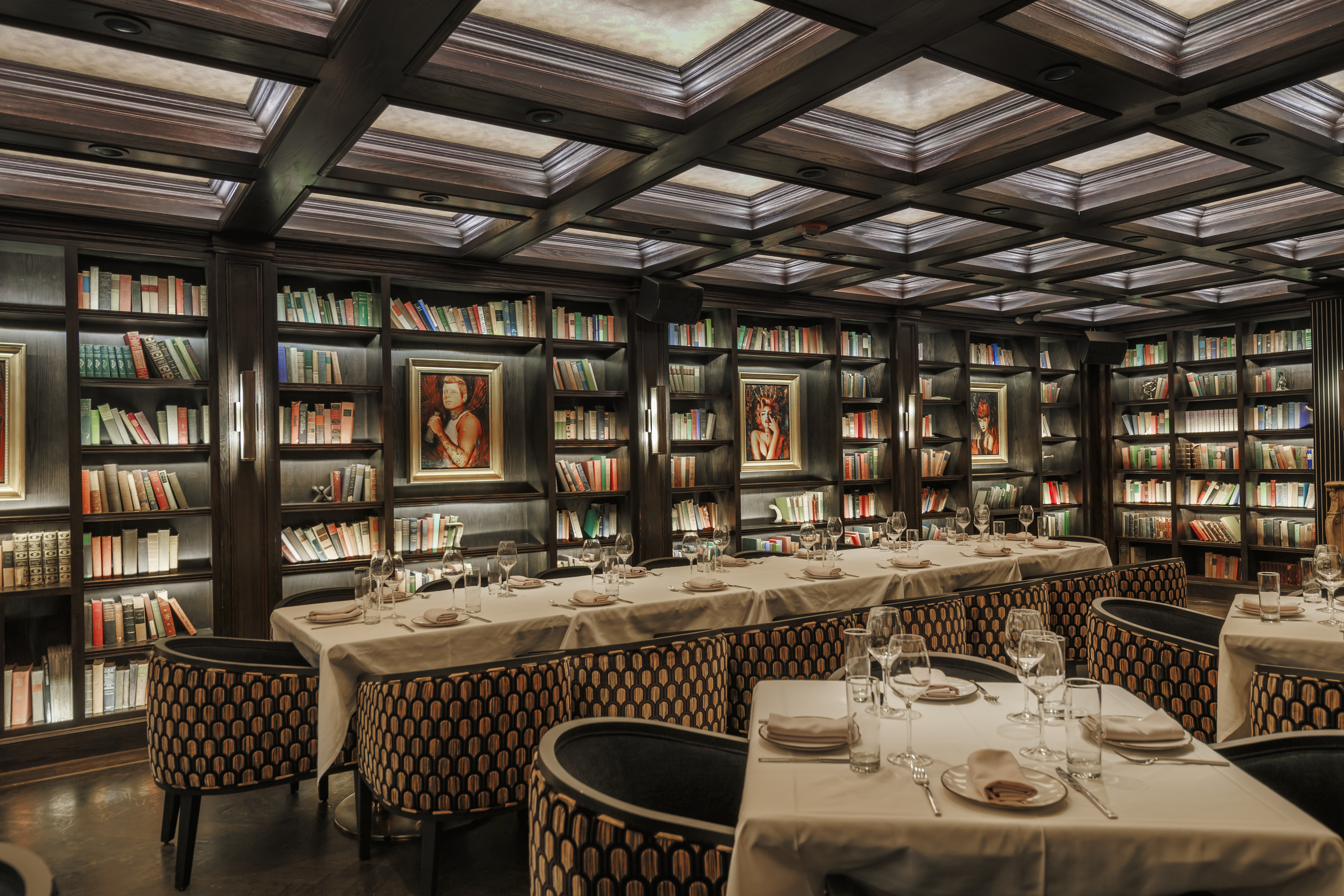 a dining room table and chairs in a library