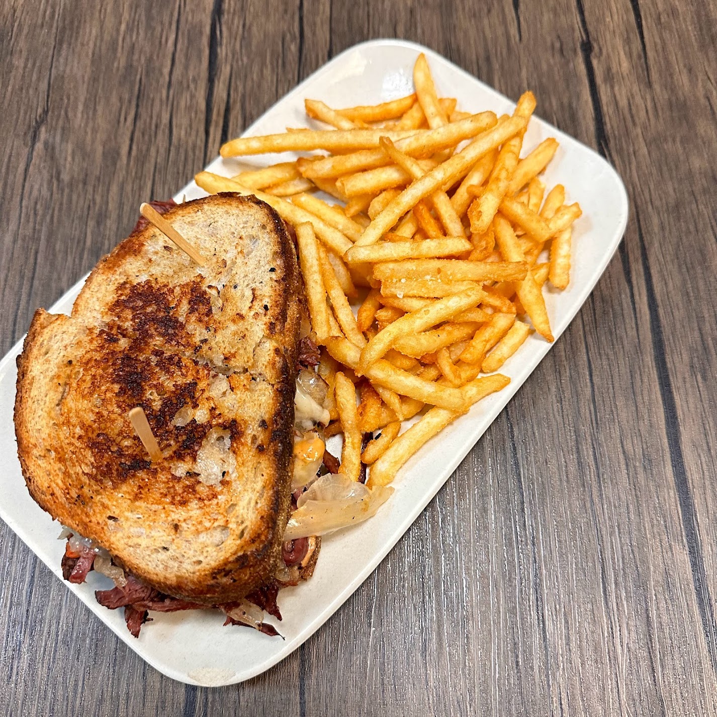 a cut in half sandwich sitting on top of a wooden table