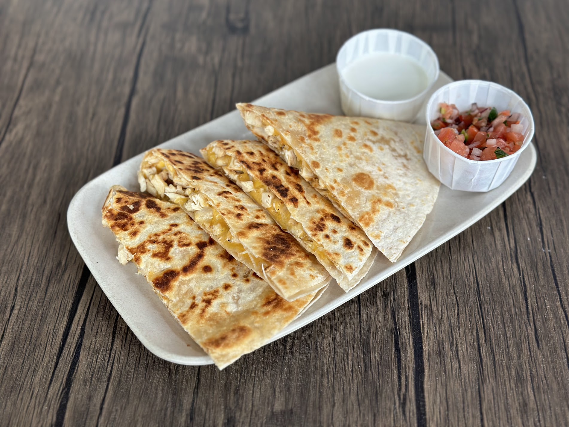 a plate of food sitting on top of a wooden table