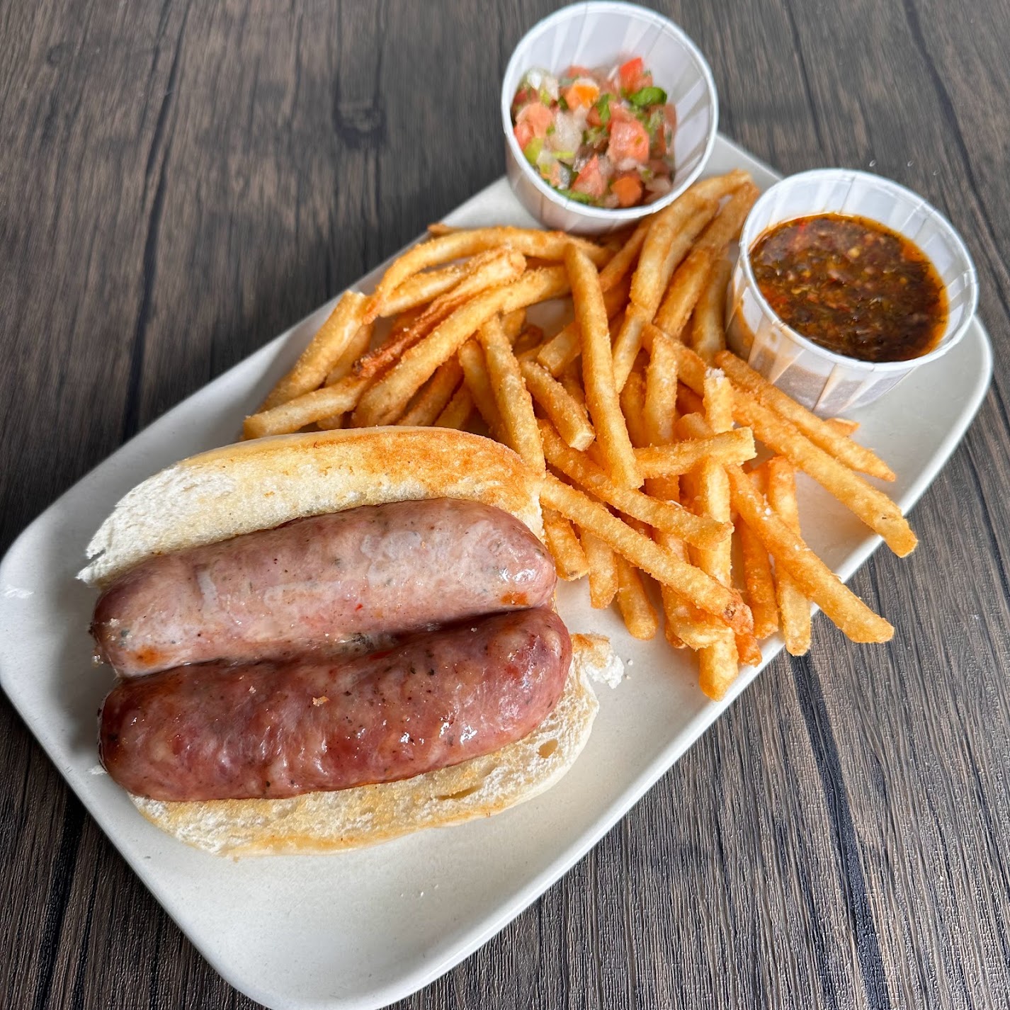 a plate of hot dogs sitting on a table