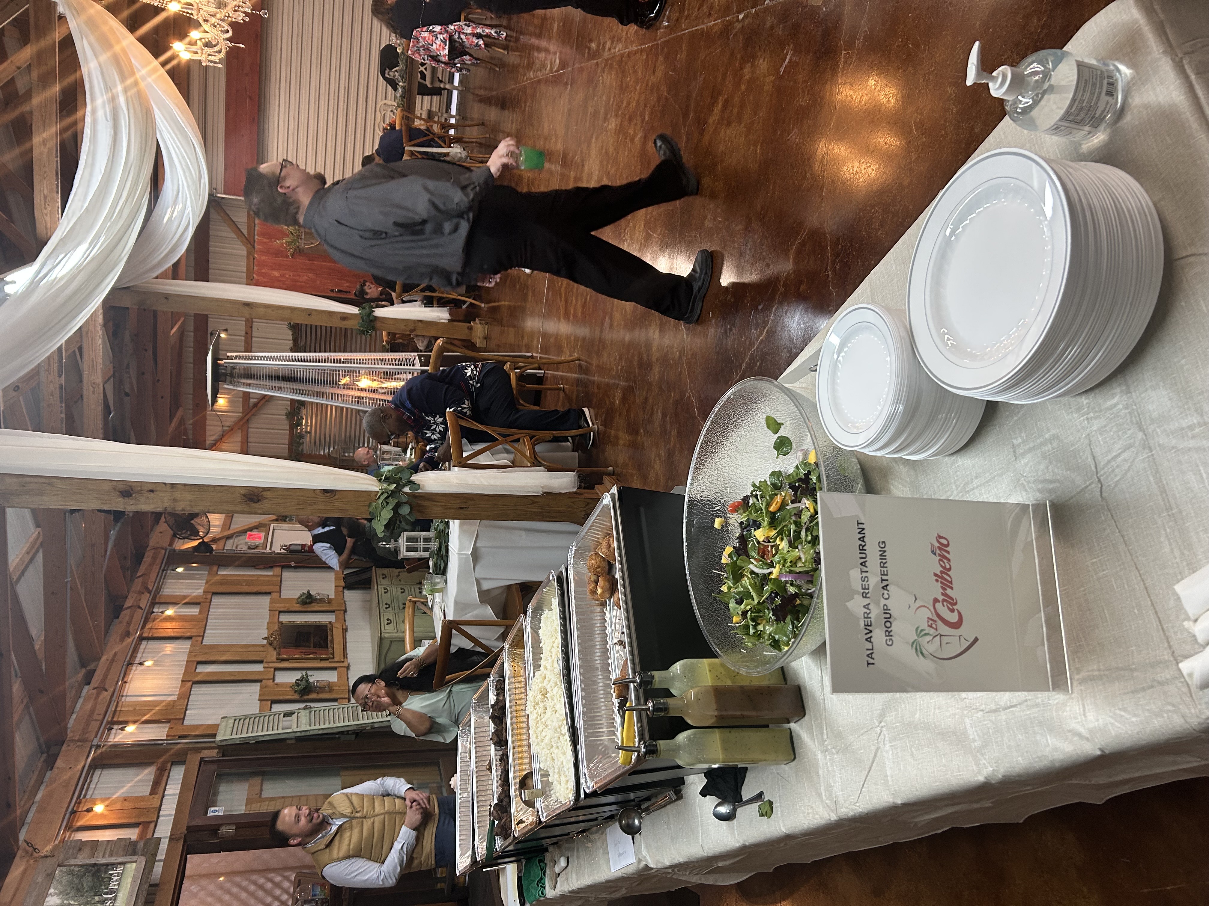 a group of people standing around a table