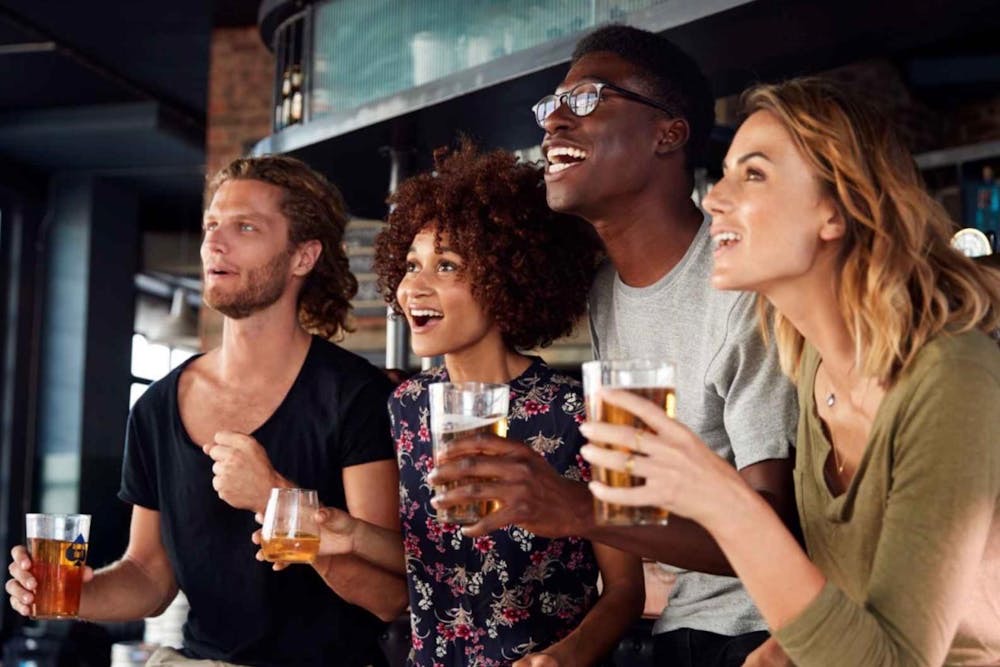 a group of people holding glasses of beer