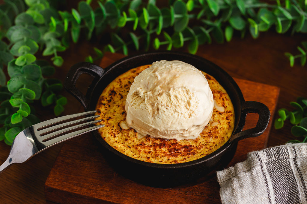 a plate with a piece of cake sitting on top of a wooden table
