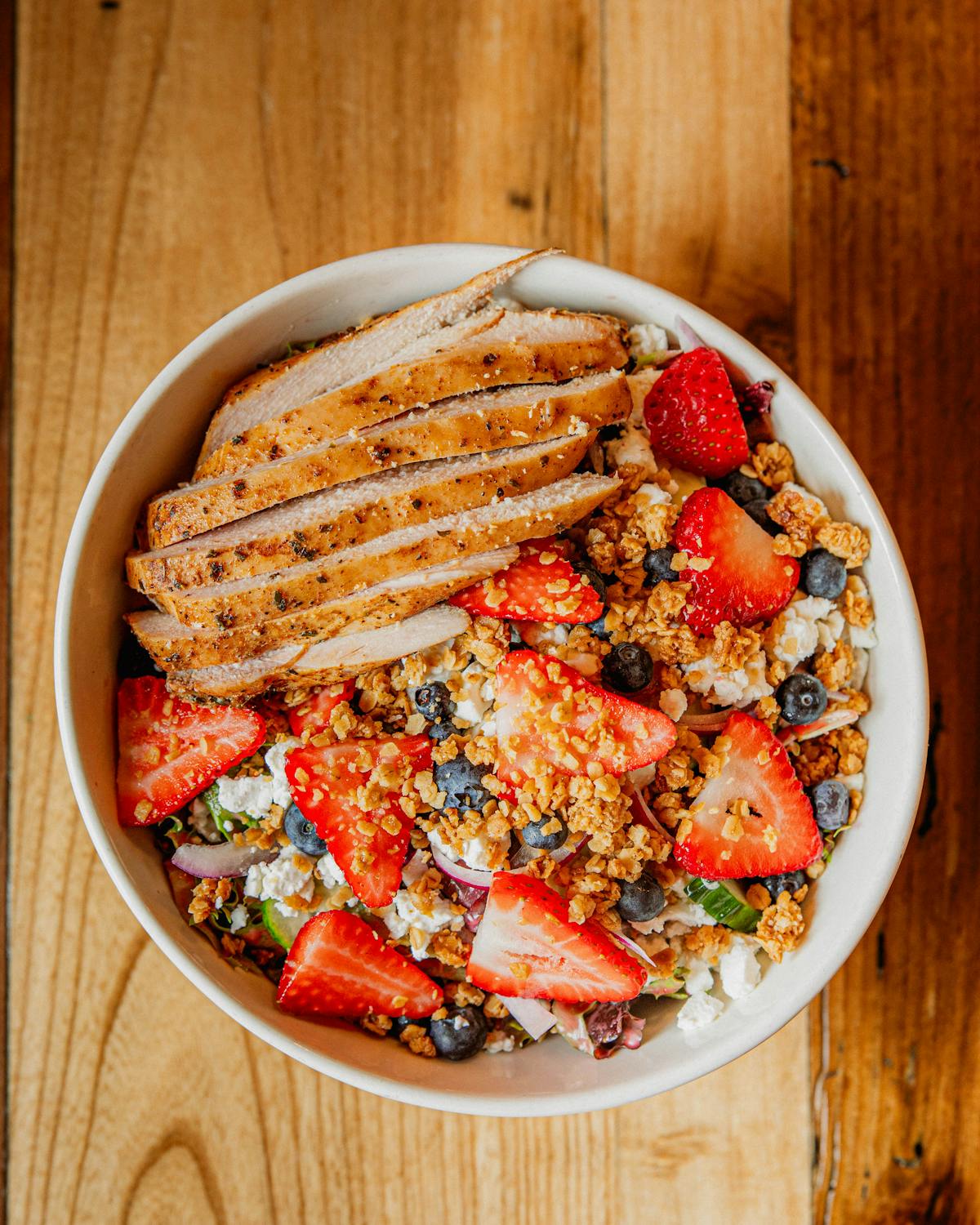 a plate of food sitting on top of a wooden table