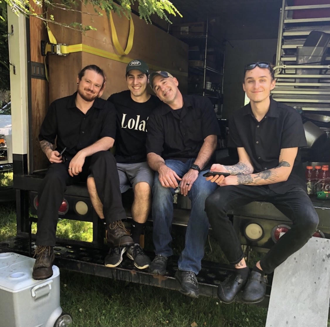 a group of people sitting on a bench posing for the camera