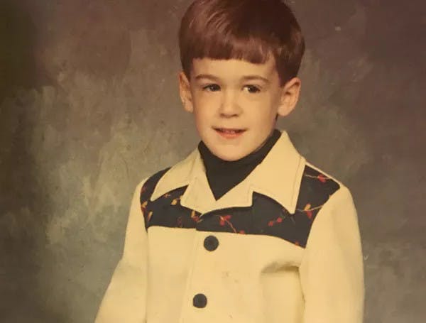 a young boy wearing a blue shirt