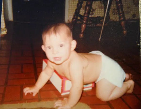 a little boy sitting on a table