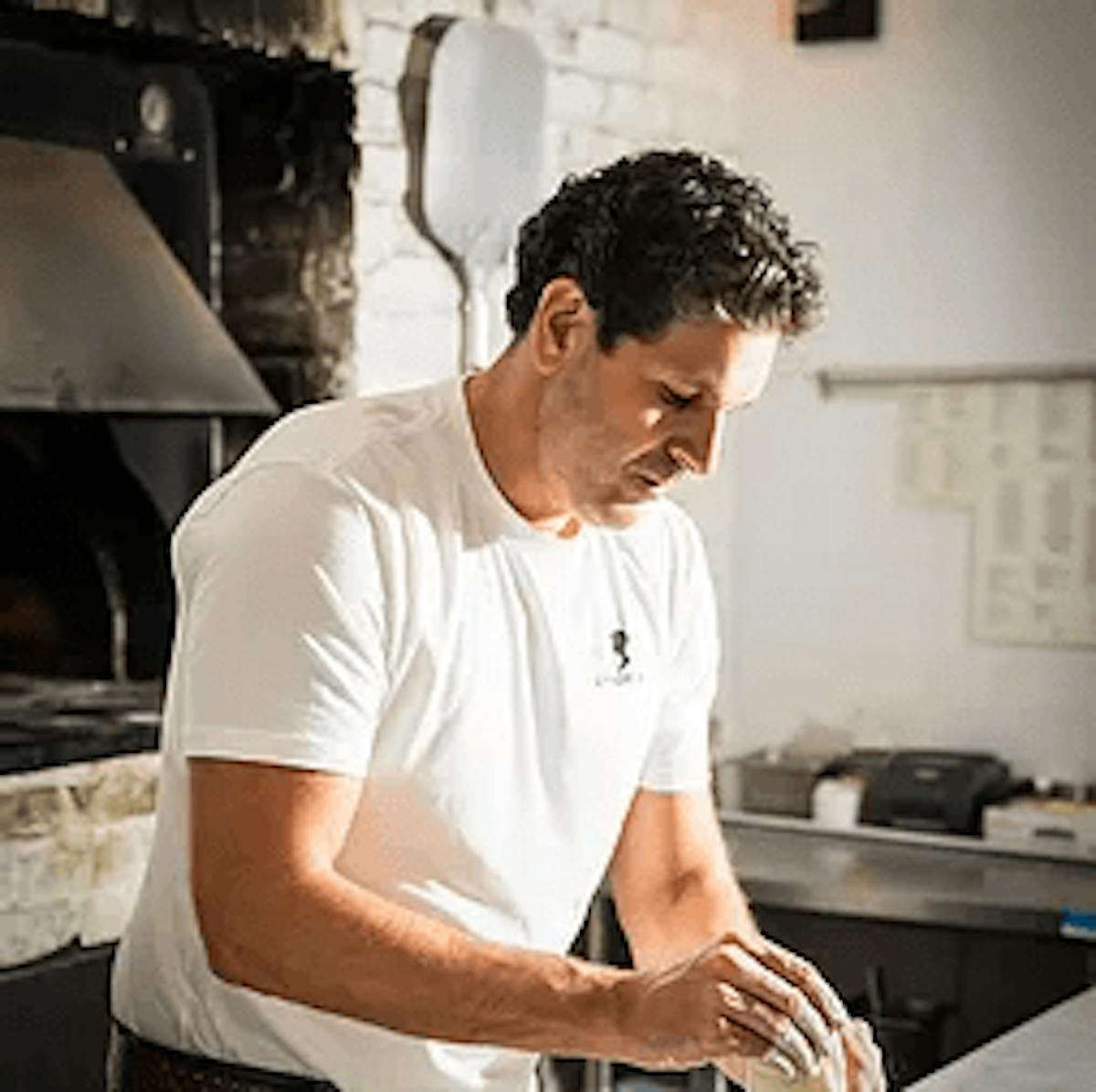 a man cooking in a kitchen preparing food