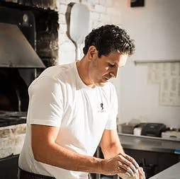 a man cooking in a kitchen preparing food