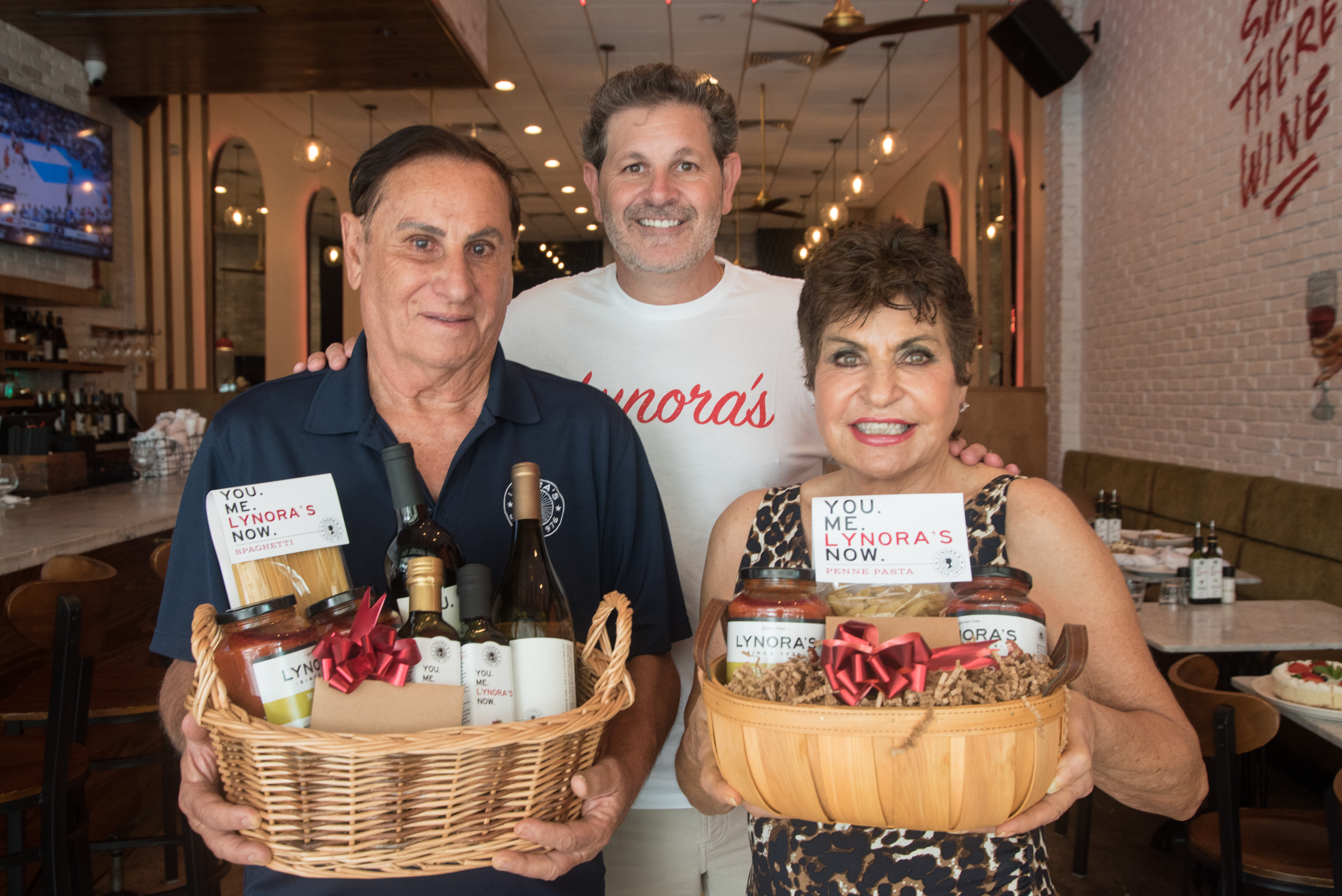 Ralph, Angelo & Maria Abbenante holding Holdiday Gift Baskets